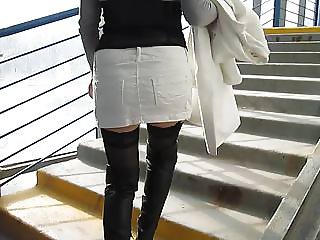 Chick in black boots and black stockings going upstairs