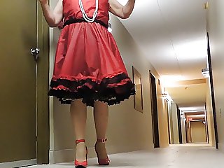 Sissy Ray in Red Teffeta dress in hotel hallway