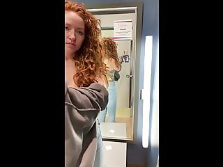 Horny girl masturbates in public changing room