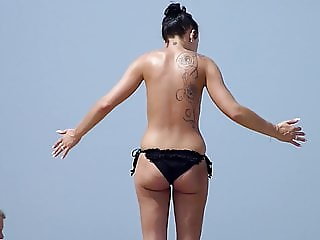 Classless chick with big tits and tattoo's on a beach