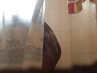 Spying on skinny black teen enjoying her shower